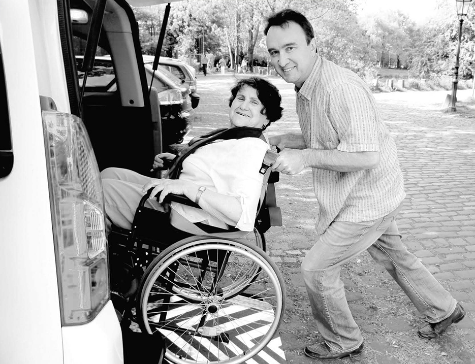 9451713 – young man assisting senior woman in wheelchair